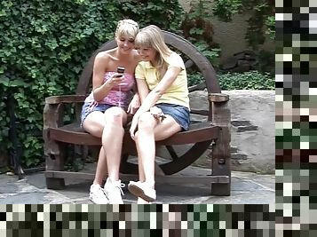 Busty chic has her lesbian pal drill her bald twat outdoors