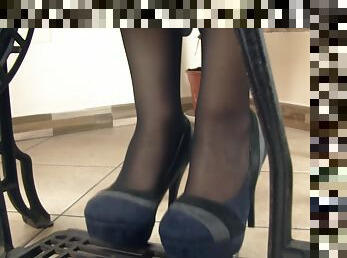 Her heels come off so she can work in her stocking covered feet