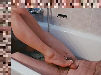 She uses her beautiful feet & hands to make him cum on his belly in the tub
