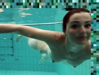 Skinny brunette strips from bikini underwater