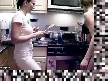 Two girls cooking naked in the kitchen