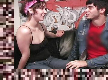 A hipster couple bangs their brains out on a leather couch