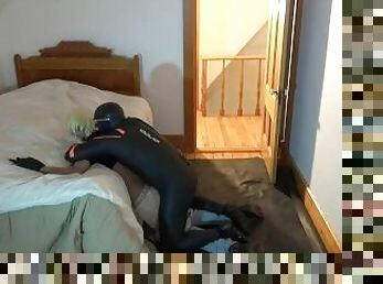 masked man in orca wetsuit has fun with jeans wearing sex doll
