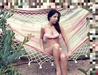 Beauty in polka dot bikini relaxes outdoors