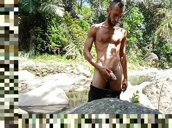 Masturbation in a tropical river and huge cumshot on a stone