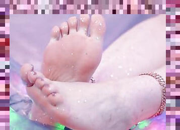 Beautiful bare feet, soles and toes with glitter play.