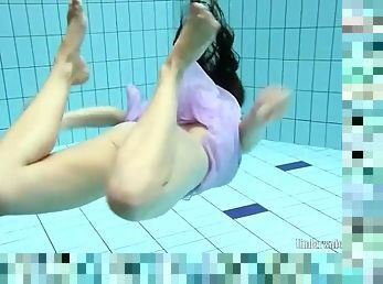 Purple dress falls off brunette in the pool