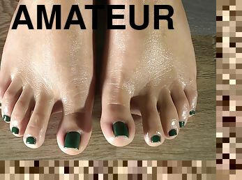 Cleaning Her Feets With A Damp Cloth And Showing Her Green Feet Fingernails. Close Up
