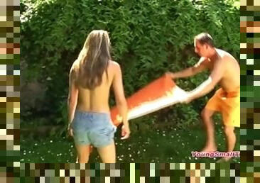 Young small tits girl with daddys best friend in the garden